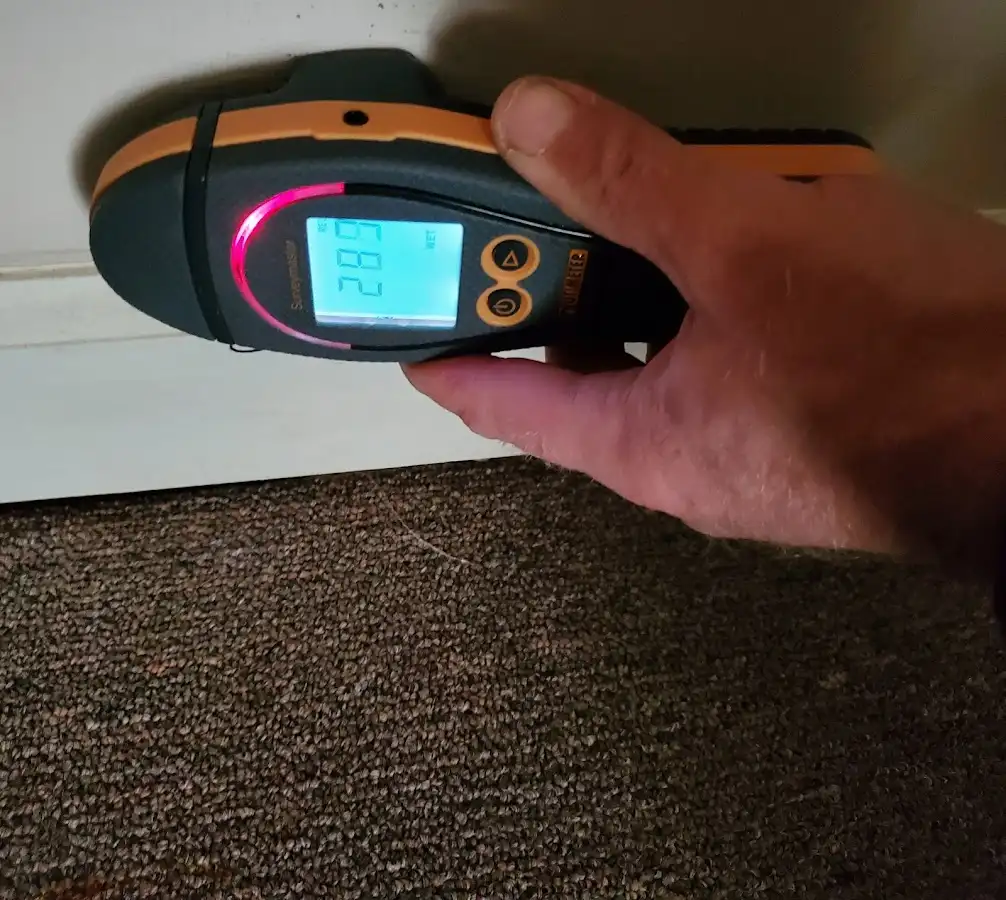 Moisture detection at baseboard during Storm Damage Restoration in Emmaus